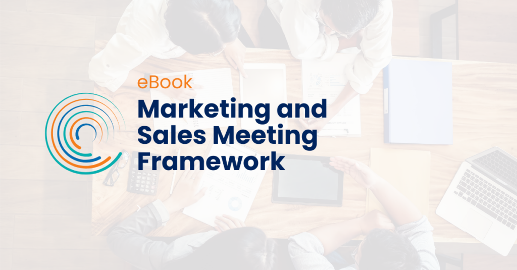 Marketing and Sales Meeting Framework ebook _ full circle icon logo- people around a table having a meeting in background, shot from above, laptops and notebooks on table